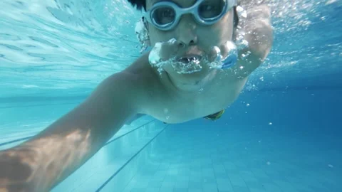 Young Man Swimming Underwater In Pool Wearing Protective Goggles Stock Footage 337910151