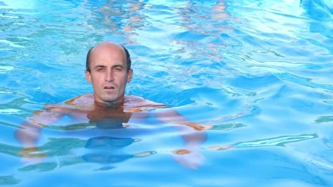 A young man swims in a pool Video stock 315030557