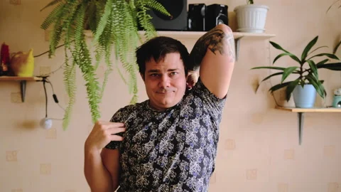 A young man in a T-shirt is doing exercises. Stock-Footage 149551698