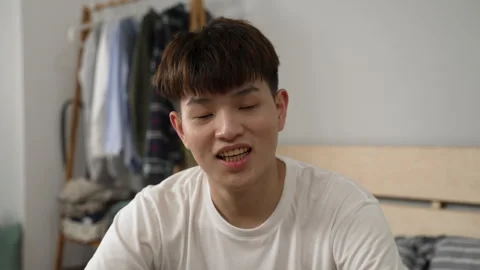 Young man in t shirt is scratching head Stock Footage 247728566