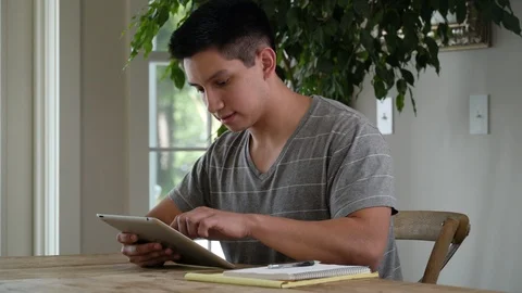 Young man at table using digital tablet. 스톡 동영상 88041533