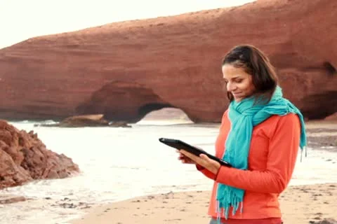 Young man with tablet computer on beautiful Legzira beach 스톡 동영상 10891798
