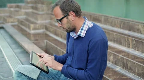 Young man with tablet computer in the city, steadicam shot HD Stock Footage