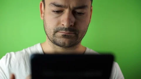 Young man with tablet computer green screen background Stock Footage 87175538