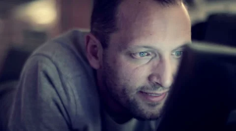 Young man with tablet computer lying on sofa HD Stock Footage 32897996