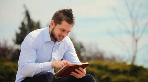 Young man with tablet computer outdoors Stock Footage 37323322