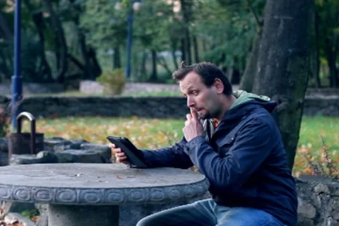 Young man with tablet computer in the park Stock Footage 8916475