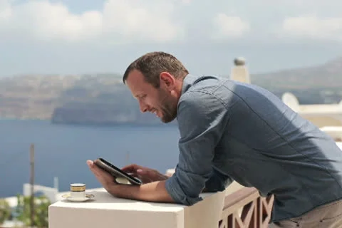 Young man with tablet computer stand on beautiful terrace NTSC Video stock 26389823