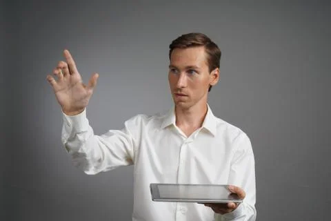 Young man with tablet computer works with a virtual interface Stock Photos