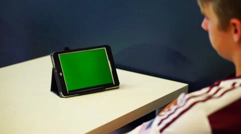 Young Man on Tablet Green Screen Video stock 63115602