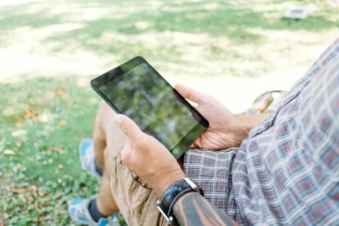 Young man with tablet in the park. Stock Photos