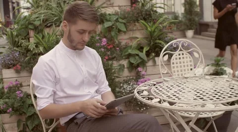 Young man tablet pc work in cafe. Handsome caucasian man using digital tablet Stock Footage 66456421