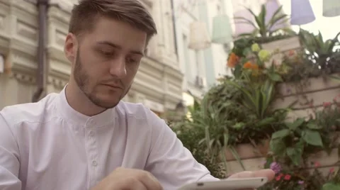 Young man tablet pc work. Handsome caucasian man using digital tablet computer Stock Footage 66456451