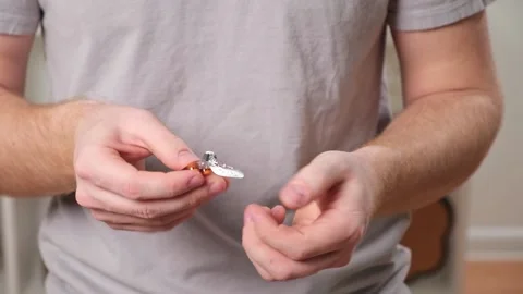A young man takes out a tablet, pill from a blister pack. The concept of health Stock Footage 238501369