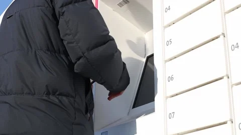 The young man takes the parcel from the box. Stock Footage 237254705