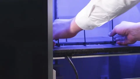 Young man takes the printed 3D printer parts Stock Footage 160491609