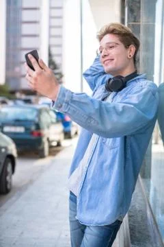 Young man takes a selfie while posing Stock Photos