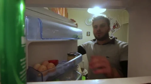 Young Man Taking Bottle Of Beer From A Refrigerator At Home Stock Footage 83137269