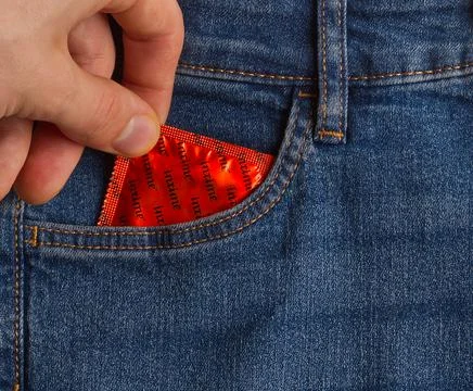 Young man taking condom from his pocket Foto stock