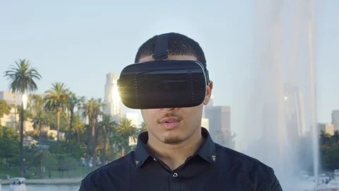 Young man taking off his VR glasses and looking at camera Stock Footage 119335664