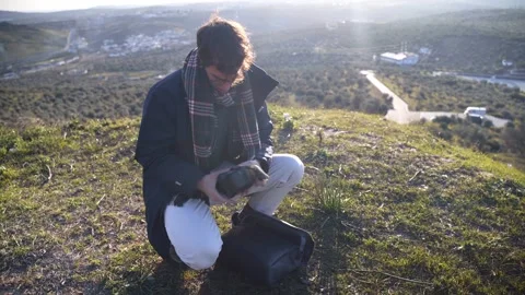Young man taking out a drone from his backpack in Portugal. Stock Footage 240397380