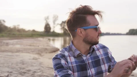 Young Man Taking a Picture With his Mobile in the Wild Stock Footage 76454242