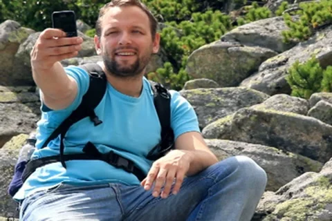 Young man taking picture with mobile phone in the mountains Stock Footage 7902577