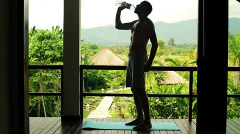 Young man taking rest after workout on luxury terrace with exotic view HD Stock Footage 40463895
