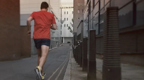 Young man taking a run through the city. Stock Footage 63018389