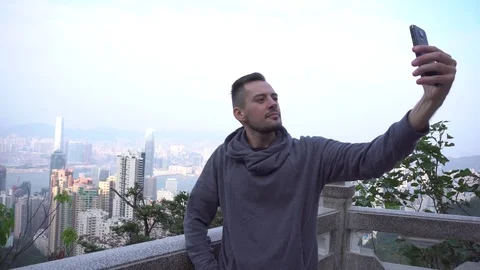 Young man taking self-portrait photo on . Beautiful young multiracial tourist Stock Footage 72110870