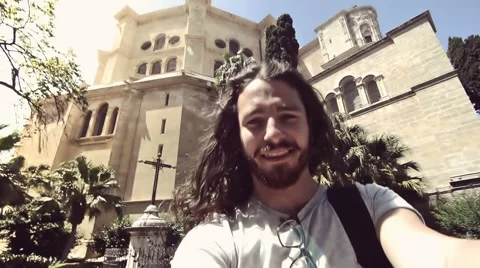 Young man taking a selfie in front of a cathedral. Instagram filter style. 스톡 동영상 63533645