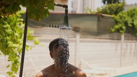 Young man taking shower in hot summer weather Video stock 280491629