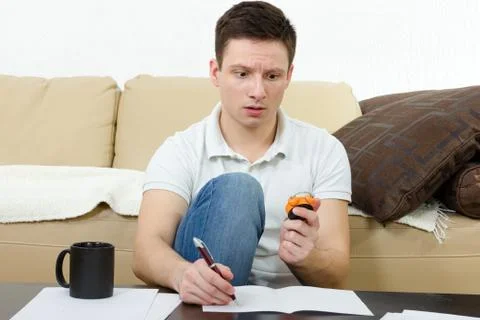 Young man taking test and counting minutes holding watch Stock Photos