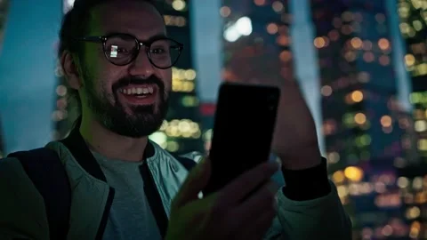 A young man taking a video call with his smartphone Stock Footage 168414625