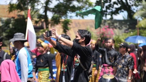 Young man taking video with smartphone in carnival Stock Footage 218044730