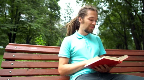 A young man is talking about a book Stock Footage 65079320
