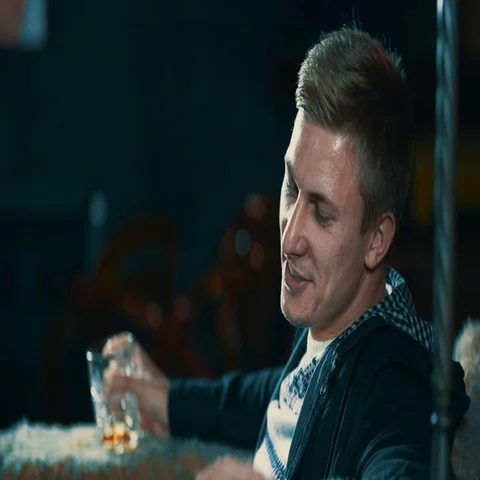 Young man talking and enjoy drink alcohol at bar 4k video. Guy whiskey glass Stock Footage 69376601