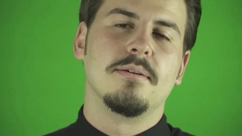 Young man talking to the camera in green screen background studio. Stock Footage 76394048