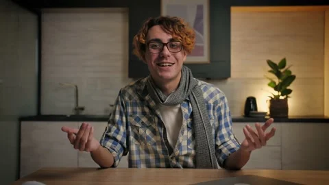Young man talking to camera make conference at home.Happy guy doing work Stock Footage 221619442