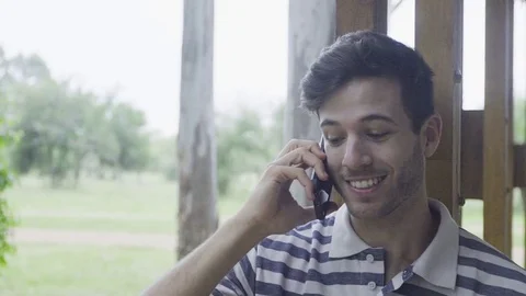 Young man talking on cell phone outdoors Stock Footage 75191229