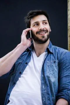 Young man talking on cell phone Stock Photos