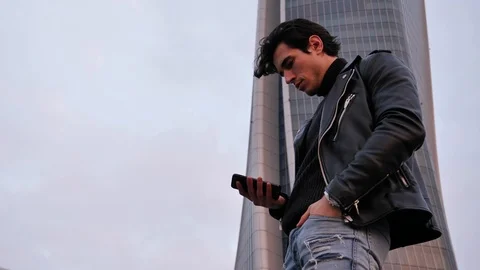 Young man in talking on cellphone outdoor in city Stock Footage 88061244