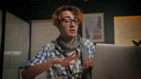 Young man talking to computer make conference at home.Happy guy doing work Stock Footage 221618729