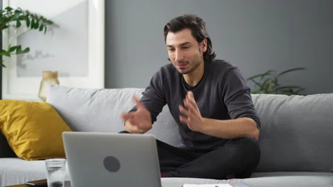 Young man talking during video conference working from home Stock Footage 149243836