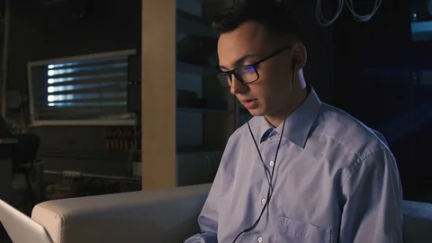 A young man talking on facetime, video chat, dark background Stock Footage 98300300
