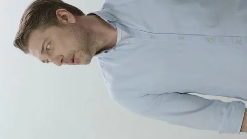The young man is talking looking at a dot to the left of the screen. Stock Footage 201030475