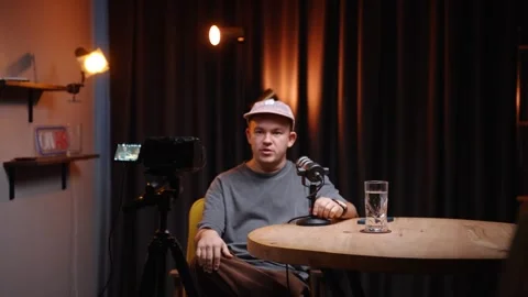 Young man talking into microphone during podcast Stock Footage 318781873