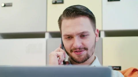 A Young Man Talking on the Mobile Indoors Stock Footage 84772393
