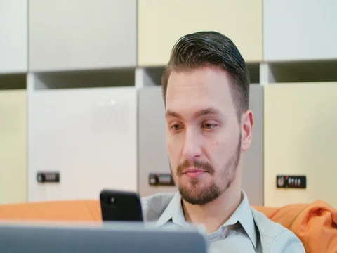 A Young Man Talking on the Mobile Indoors Stock Footage 84774333