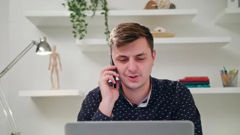 A Young Man Talking on the Mobile in the Office Stock Photos